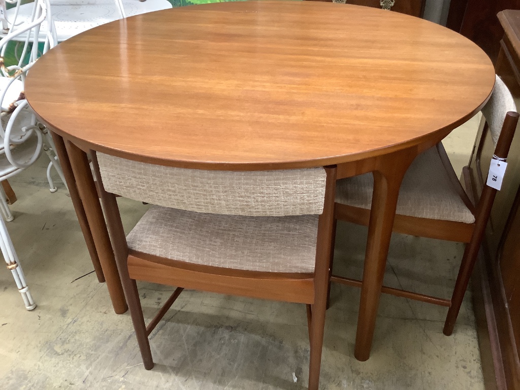 A mid century design Macintosh circular teak extending dining table and four chairs, model 9533, table width 170cm extended depth 122cm height 74cm